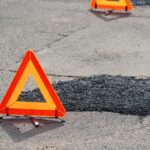 Fresh,Asphalt,Patch,Marked,By,Warning,Triangle,For,Safety.,Roadwork.